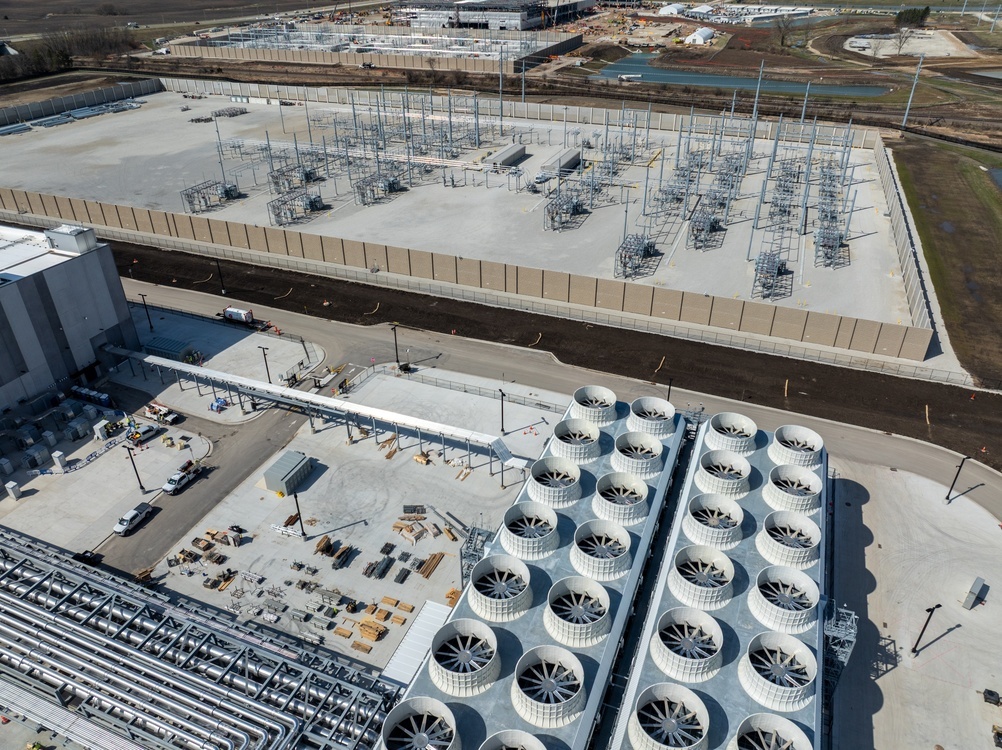 Aerial view of an AI data center campus with cooling fans